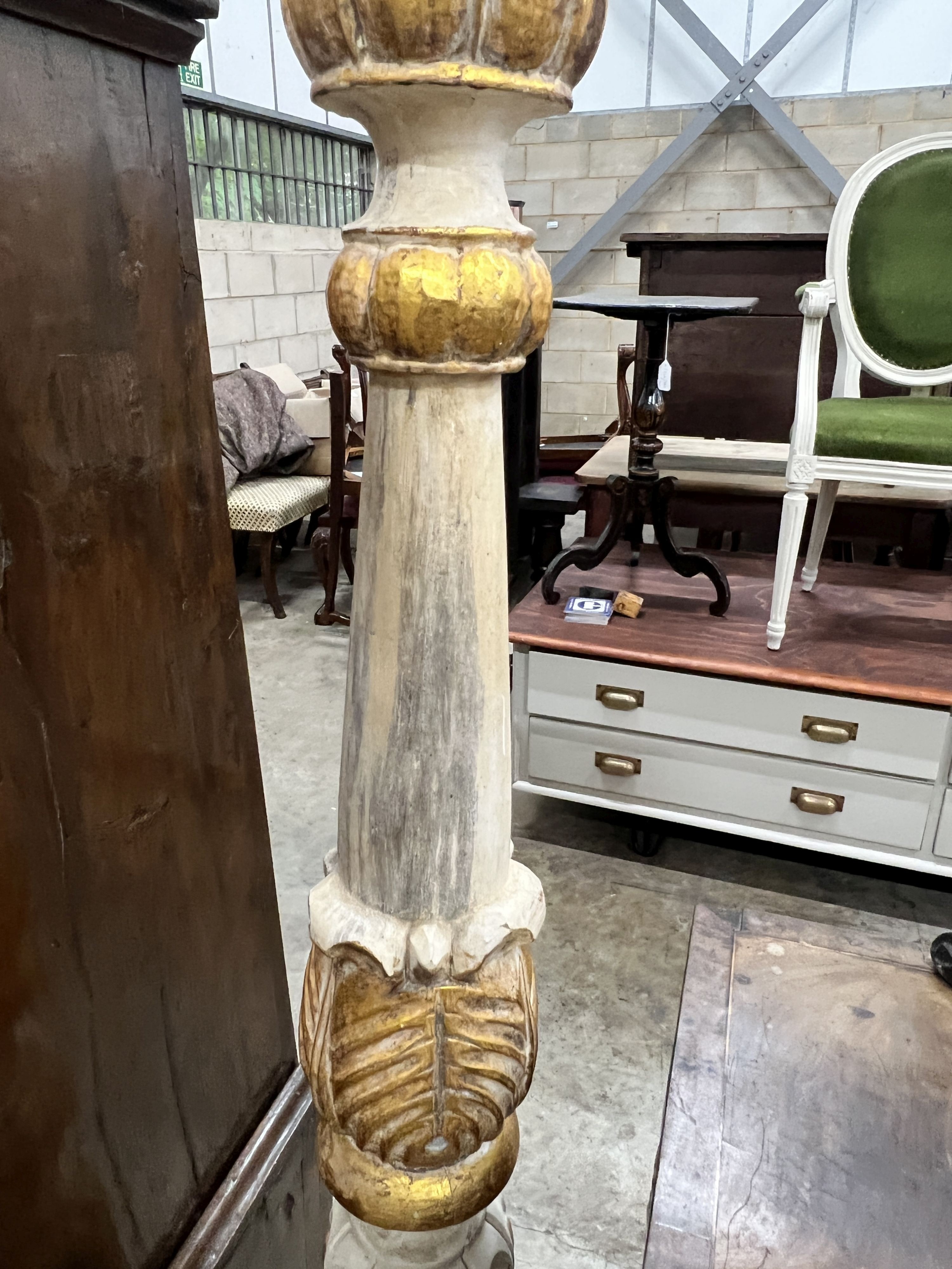 A pair of Italian style painted parcel gilt pricket candlesticks, height 150cm